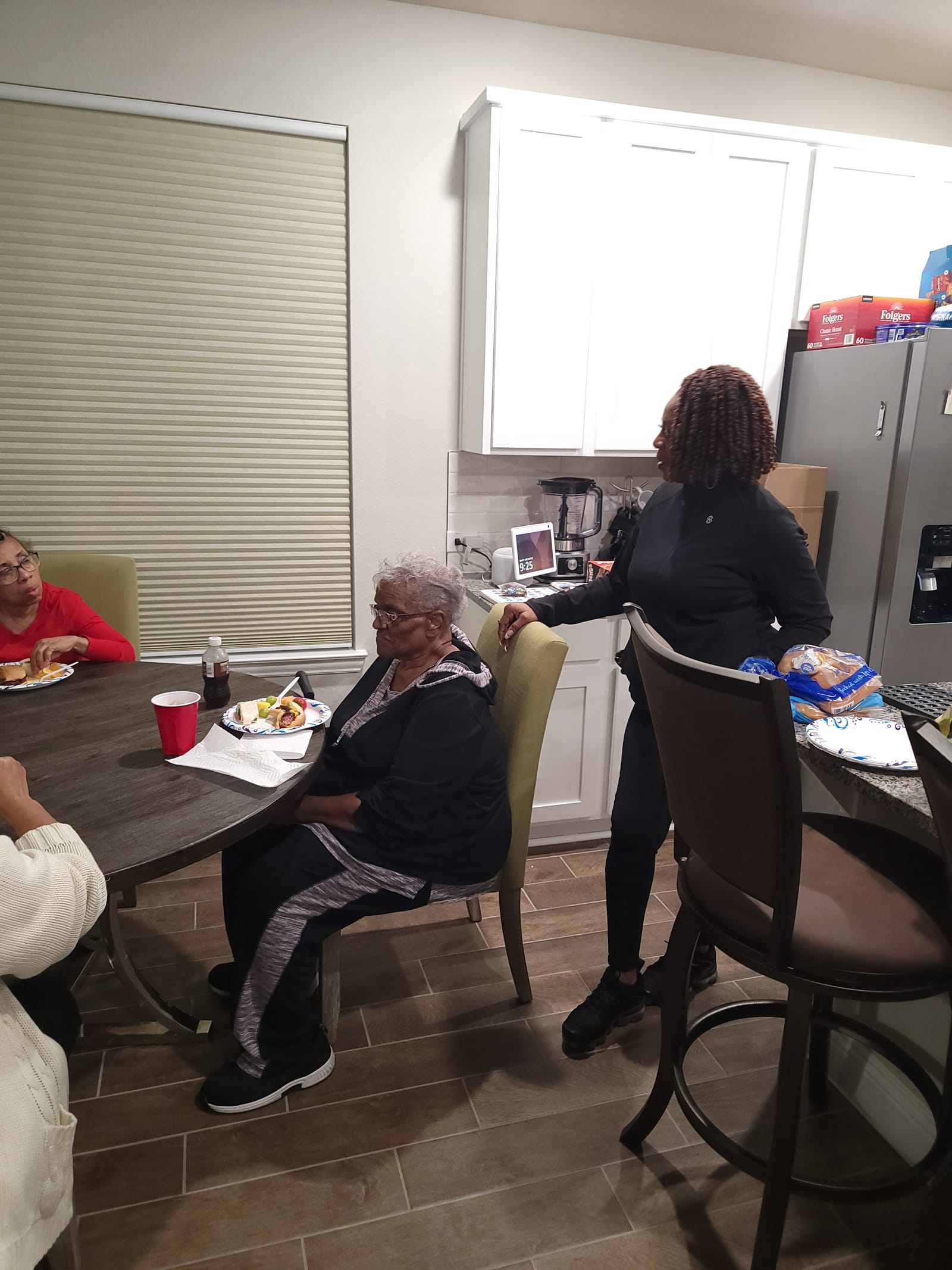 Sheila serving seniors at a community room table