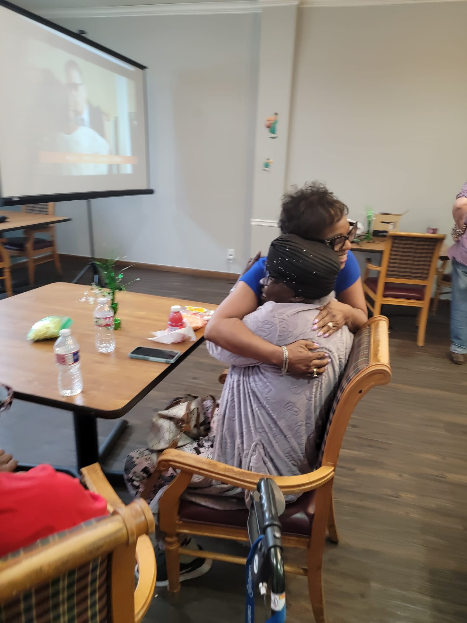 Seniors watching a film on the big screen at movie day