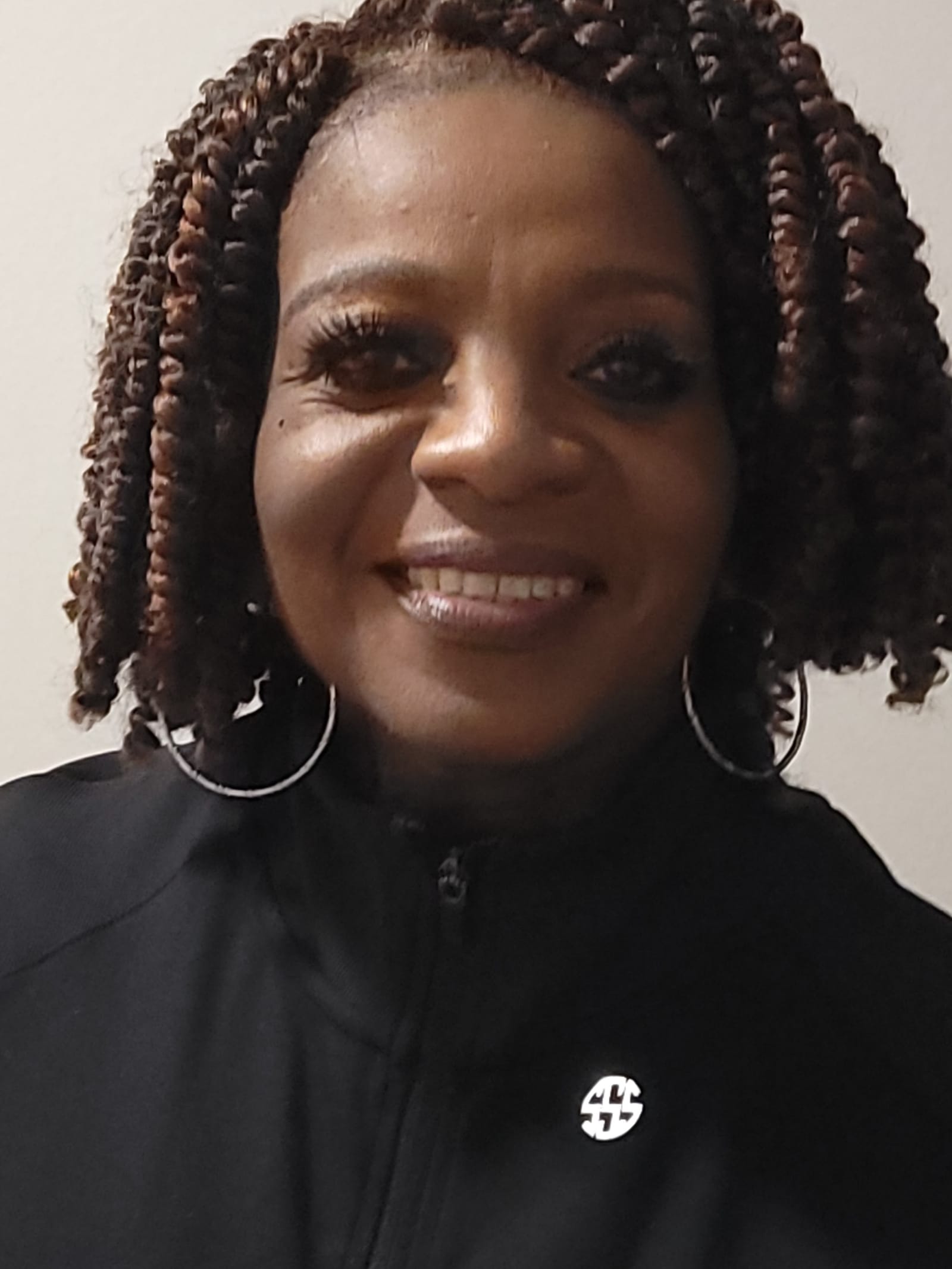Sheila Smith, founder of Sheila's Silver Saints, smiling in a black jacket