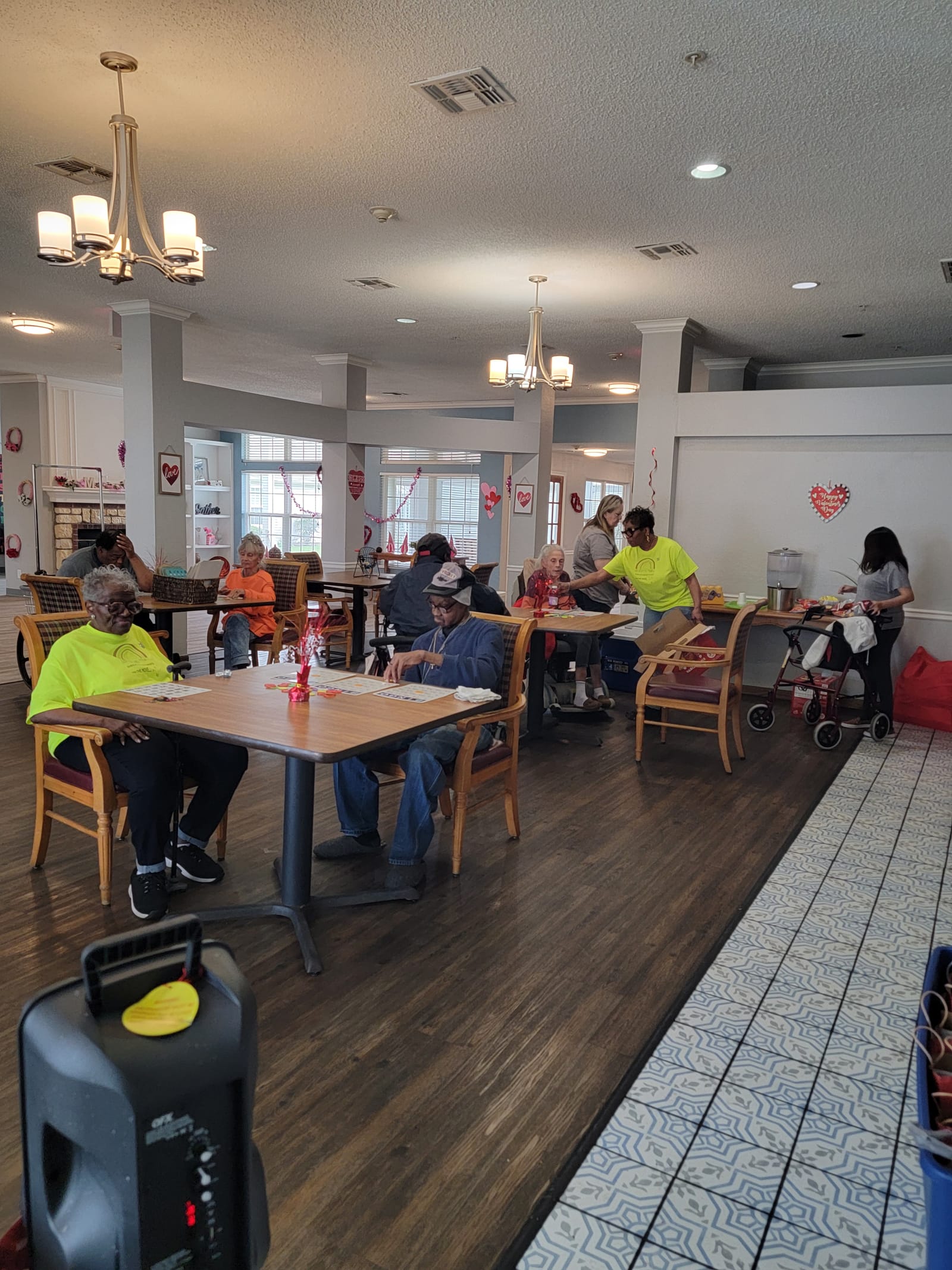 Seniors seated for movie day with snacks on the tables