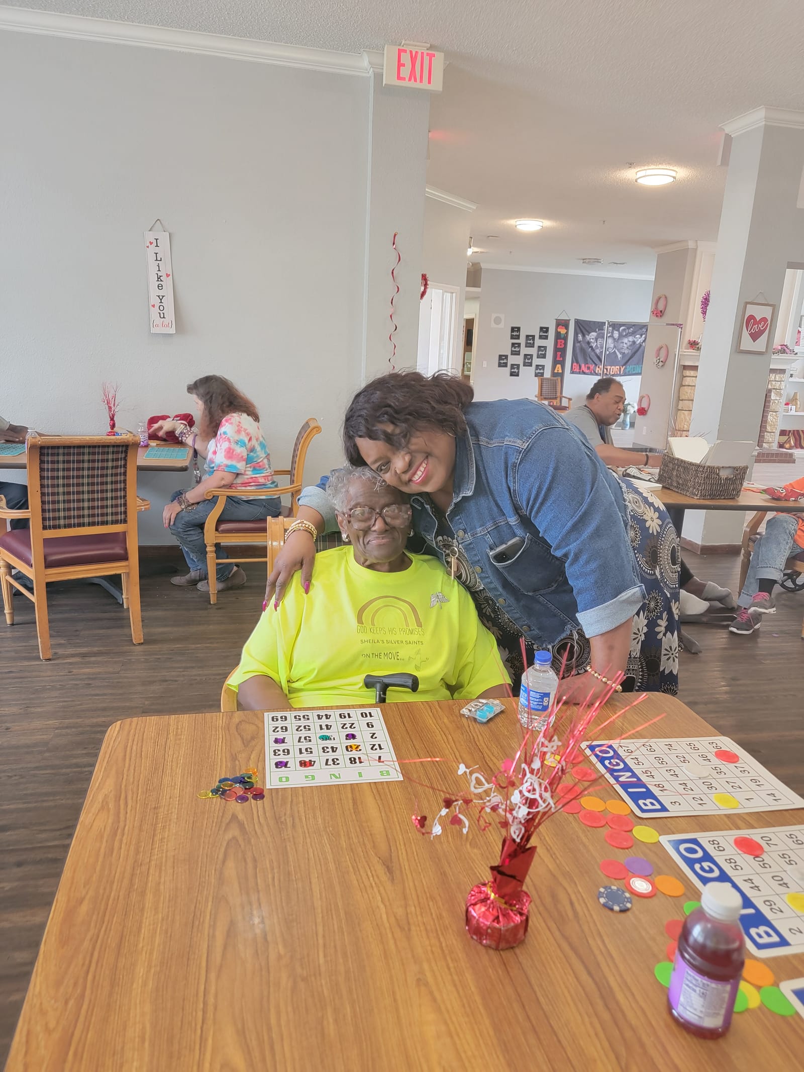 A volunteer helping a senior with her bingo card