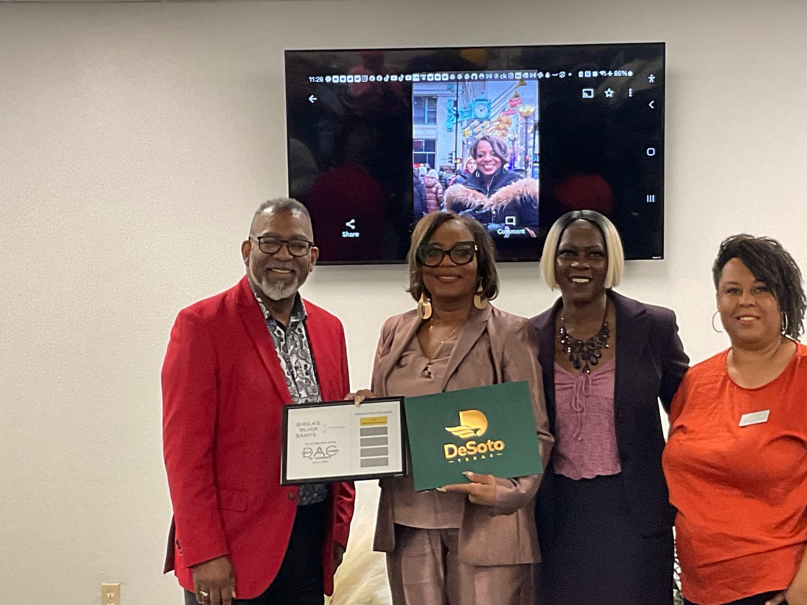 Sheila Smith holding a plaque naming Sheila's Silver Saints a proud member of the DeSoto Area Chamber of Commerce since 2024