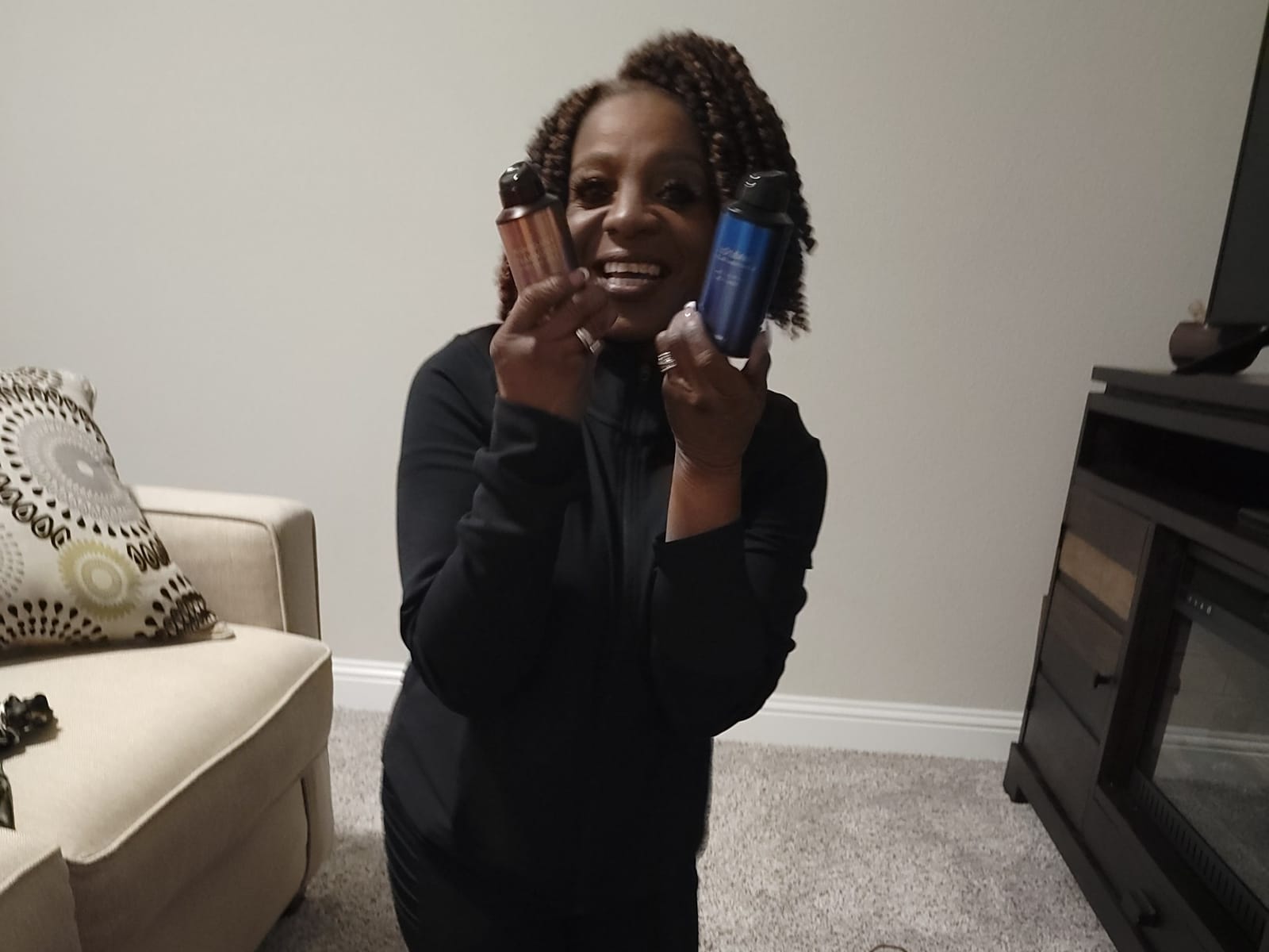 Sheila Smith holding up a prize in a living room